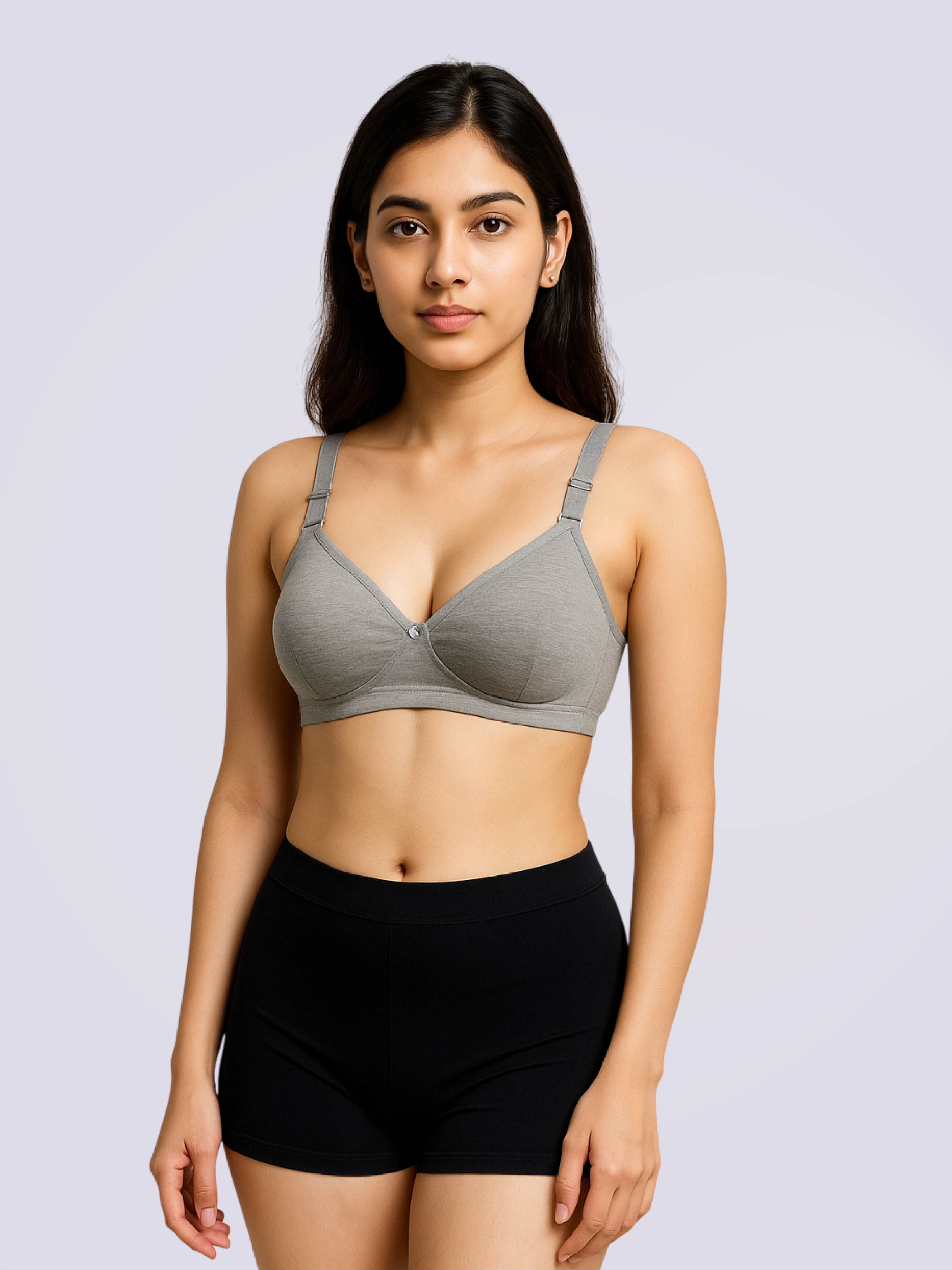 Woman wearing a gray bra and black underwear on a light purple background